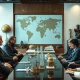 Adrian Cheng discussing cultural commerce strategy with international leaders in formal meeting setting