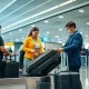 Airline staff measuring oversize bags at check-in counter for bonus incentives