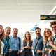 Happy travelers experiencing the positive impact of American Airlines customer strategy at an airport.