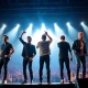 The Backstreet Boys performing live on stage, showcasing their enduring career and significant Backstreet Boys net worth.