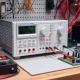 A reliable bench power supply on a workbench, providing stable power for intricate electronics projects and testing.