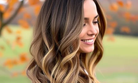 A woman confidently showcases voluminous, natural-looking Best Clip-In Hair Extensions UK, perfect for an autumn transformation.