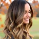 A woman confidently showcases voluminous, natural-looking Best Clip-In Hair Extensions UK, perfect for an autumn transformation.