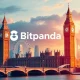 Bitpanda UK market entry depicted by a vibrant digital interface overlaying London skyline, symbolizing its ambitious expansion.