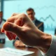 A chart showing economic data being scrutinized by a hand, symbolizing the critical review of a BLS nominee claim.
