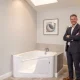 Jason McCullough stands proudly beside a modern Boca Walk-In Tub, symbolizing the company's commitment to pioneering innovation and home independence.