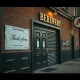 Facade of a historic brewery with closed doors, signifying its permanent brewery closing after decades of service.