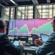 Wall Street analysts showing bullish stock market confidence with rising market charts and positive indicators