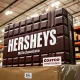 A giant Hershey's Milk Chocolate Bar on display in a Costco aisle, symbolizing the significant Costco Hershey partnership.