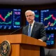 Federal Reserve official announcing September interest rate cuts decision during policy meeting