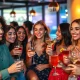 Young adults making mindful choices about Gen Z alcohol consumption in a social setting, reflecting a strategic approach to indulgence.