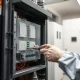 Technician carefully inspecting internal HIU components for reliable home heating performance.
