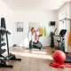 A person engaging in a full-body workout using modern Home Gym Equipment in a well-lit home gym.