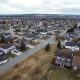 Homes taking longer to sell with multiple for sale signs in neighborhood showing increased market inventory