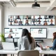 Hybrid teams collaborating in modern flexible workspace with remote participants