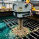 Hydraulic trash rack cleaning machine removing debris from water intake with advanced scanning technology