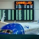 JetBlue flight cuts announcement showing airplane at terminal with cancellation notice
