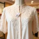 A close-up of a delicate, elegant Macy's lace blouse, showcasing its intricate details and texture, highlighting the exceptional value.