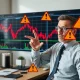 Financial strategist analyzing market pullbacks warning signals on stock chart