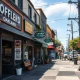 A bustling Oakland street scene demonstrating how a small business integrates technology for growth and community connection.