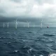 A struggling offshore wind farm with incomplete turbines, representing the financial challenges faced by Orsted US wind projects.