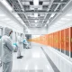 Advanced particle contamination control in modern cleanroom facility with technicians monitoring air quality