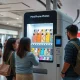 Modern phone case printing vending machine creating custom designs for customers in retail environment