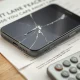 Documents and a calculator surround a broken smartphone, illustrating the financial struggles leading to a Phone Service Provider Bankruptcy.