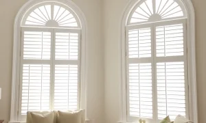 Elegant white plantation shutters enhance a modern living room, offering privacy and light control. This image illustrates the style and functionality of high-quality Plantation Shutters.