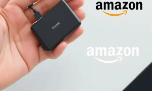 A compact portable charger connected to a smartphone, highlighting its convenience and the Amazon deal.