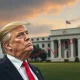 President Trump gesturing towards economic charts, symbolizing his push for a rate cut and its impact on the economy.