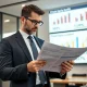 A person reviews financial documents with a calculator and a 401(k) statement, illustrating the considerations of private equity investment for retirement planning.