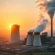 A modern coal power plant with steam plumes, representing the complex and persistent future of coal in global energy discussions.