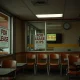 An empty fast-food restaurant dining area with a 'Closed' sign, symbolizing recent restaurant closures in the industry.