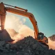 Excavator using rock cutting saw for precise construction trenching in solid bedrock