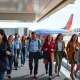 A diverse group of passengers smiling as they board a Southwest Airlines plane, highlighting an improved Southwest Airlines passenger experience.
