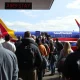 Passengers line up to board a Southwest Airlines plane, illustrating the end of the popular Southwest boarding hack.