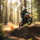 Talaria Sting R MX4 electric dirt bike performing an off-road jump on mountain trail