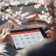 A close-up of a smartphone displaying a Japanese learning app, symbolizing effective Japanese learning apps for achieving fluency.