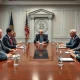 Crypto-friendly Fed chair candidates discussing monetary policy with Bitcoin symbolism in background