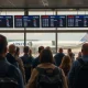 Passengers experience significant United Airlines Delays at a busy airport terminal, with many flights showing as grounded due to a technical issue.