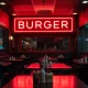 Closed upscale burger chain location showing empty dining area and dark signage