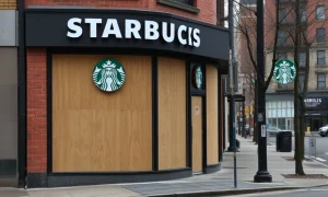 A closed Starbucks storefront symbolizing urban economic challenges in a struggling city. The boarded windows convey a sense of decline.