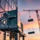 A modern Smartlift glazing robot, a type of vacuum lifter, safely installing a large glass panel on a construction site, demonstrating efficient material handling.