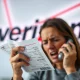 A frustrated customer confronting a Verizon representative, symbolizing challenges in Verizon customer retention after discount changes.