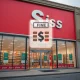 Illustrates the Walmart overcharging settlement, showing a large retail store and a symbol of financial penalty, emphasizing consumer protection.