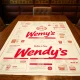 Wendy's CEO's new Wendy's menu plan laid out on a table, symbolizing a strategic effort to revitalize the struggling burger chain.