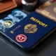 American Express NFT passport stamps displayed on digital device showing blockchain travel souvenirs