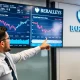 Analyst discussing crucial Fed rate cuts prediction with economic charts
