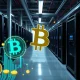 Bitcoin mining equipment facility showing modern ASIC miners in industrial setting with investment opportunity graphics